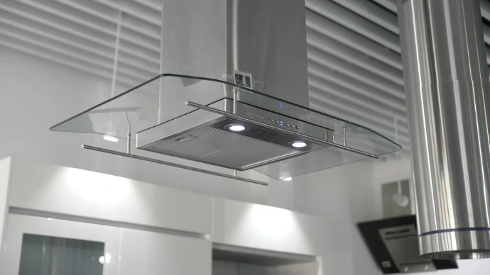 a kitchen hood mounted on the wall above a stove